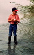 Boy fishing in stream