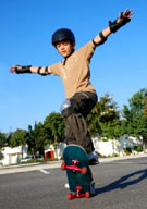 Boy skateboarding in parking lot