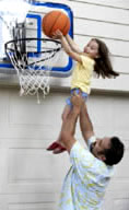 Dad Lifting Girl to Net