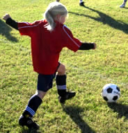 Girl dribbling soccer ball