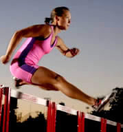 Girl jumping hurdles