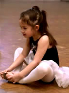 Little girl ballerina stretching