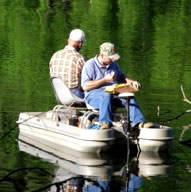Men fishing on flat boat
