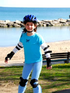 Young Girl rollerblading with helmet